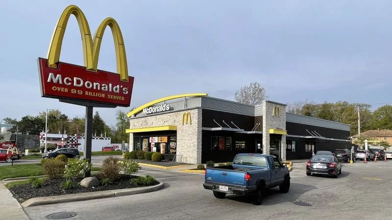 A line of cars waits in the drive-through lane of McDonald’s