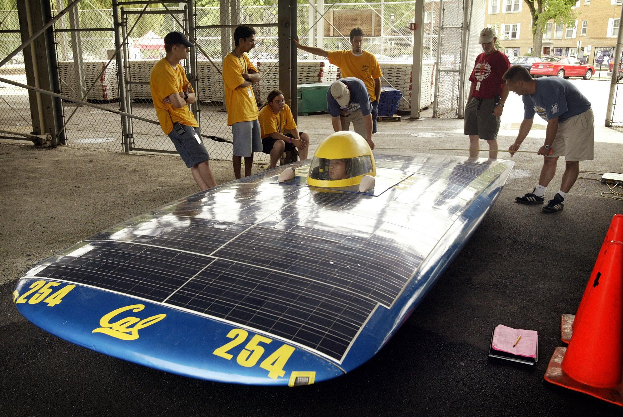 Students from the University of California push the "Solar Bear" their entry in the solar power auto race