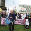Climate protestors hold signs in Edinburgh wanting justice for climate change.